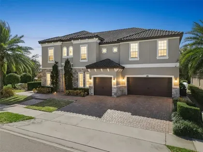 Front of the home in daylight with paver driveway